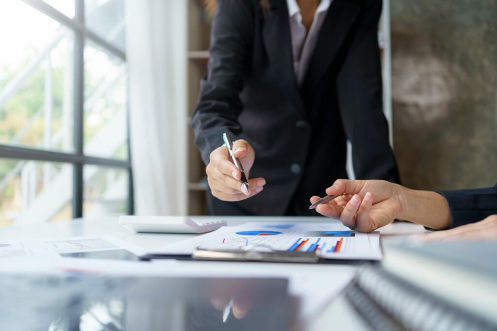 Business people analyzes graphs and charts to examine and analyze company finances revenues