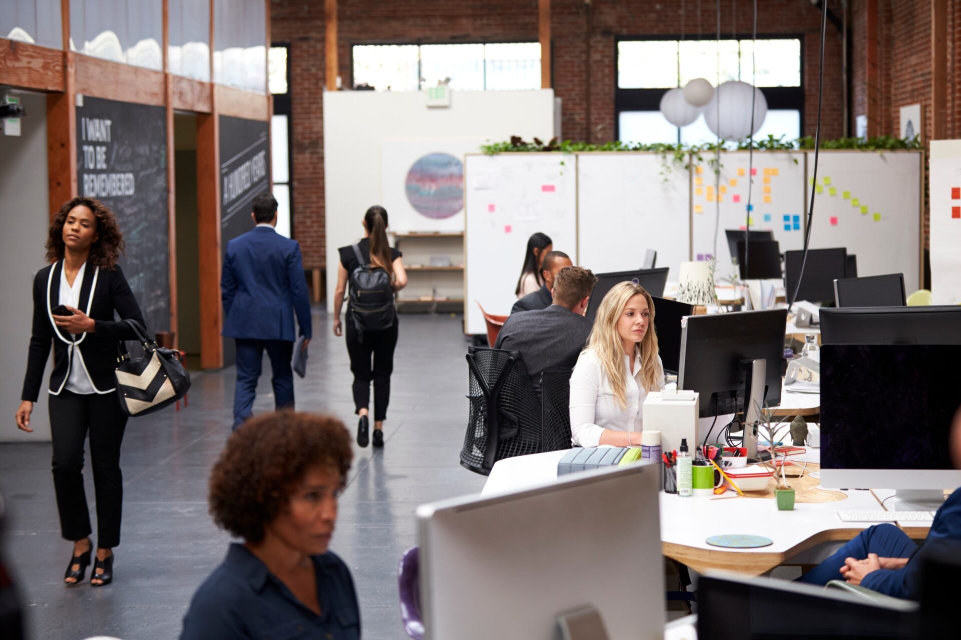 Business team working at desks in modern open plan office